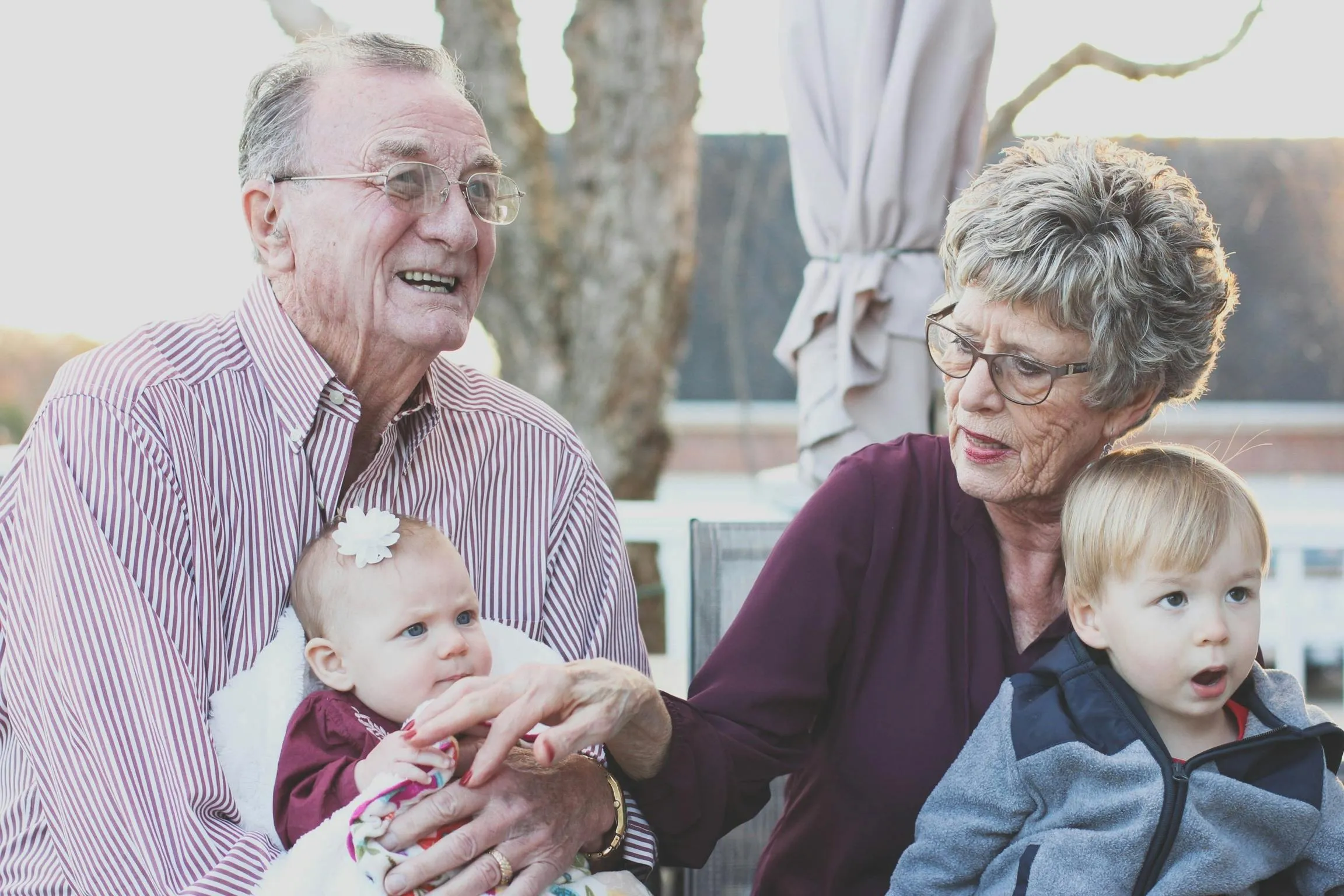 Grandmother and Grandfather Holding Grandchildren